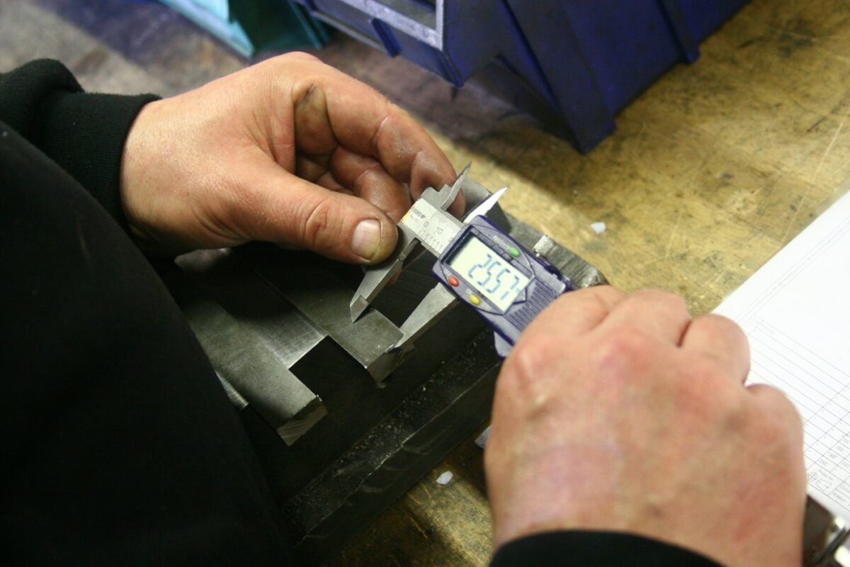 Measuring a metal part with a digital caliper