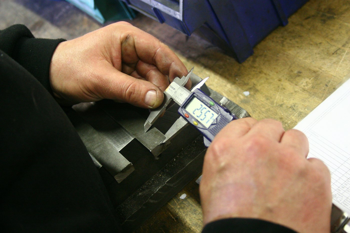 Measuring a metal part with a digital caliper